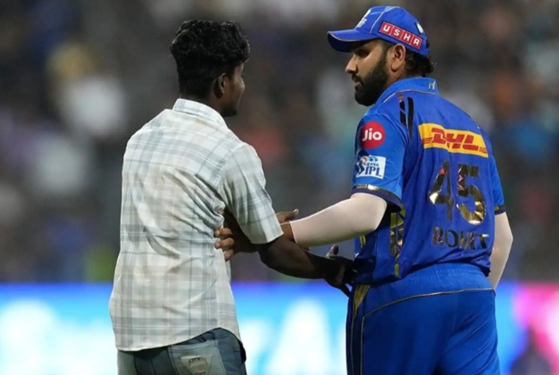 A fan breaches security to hug Rohit Sharma during MI vs RR match at Wankhede Stadium