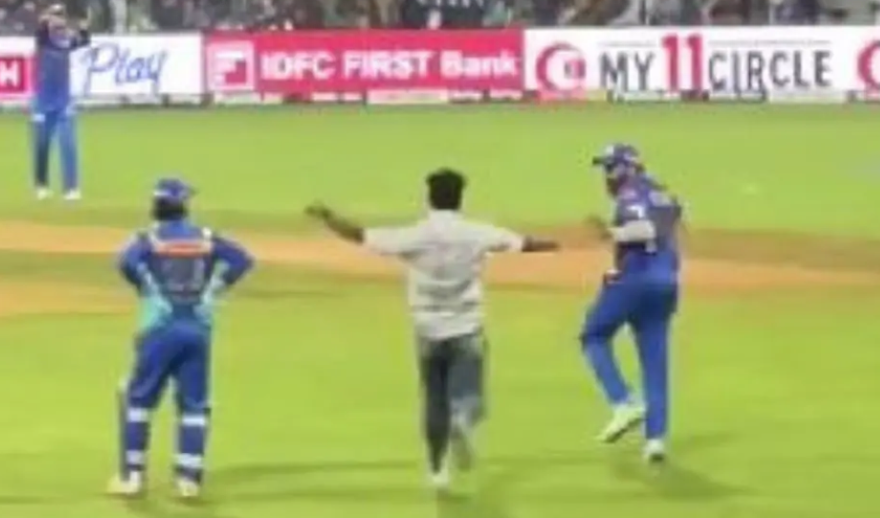 A fan breaches security to hug Rohit Sharma during MI vs RR match at Wankhede Stadium