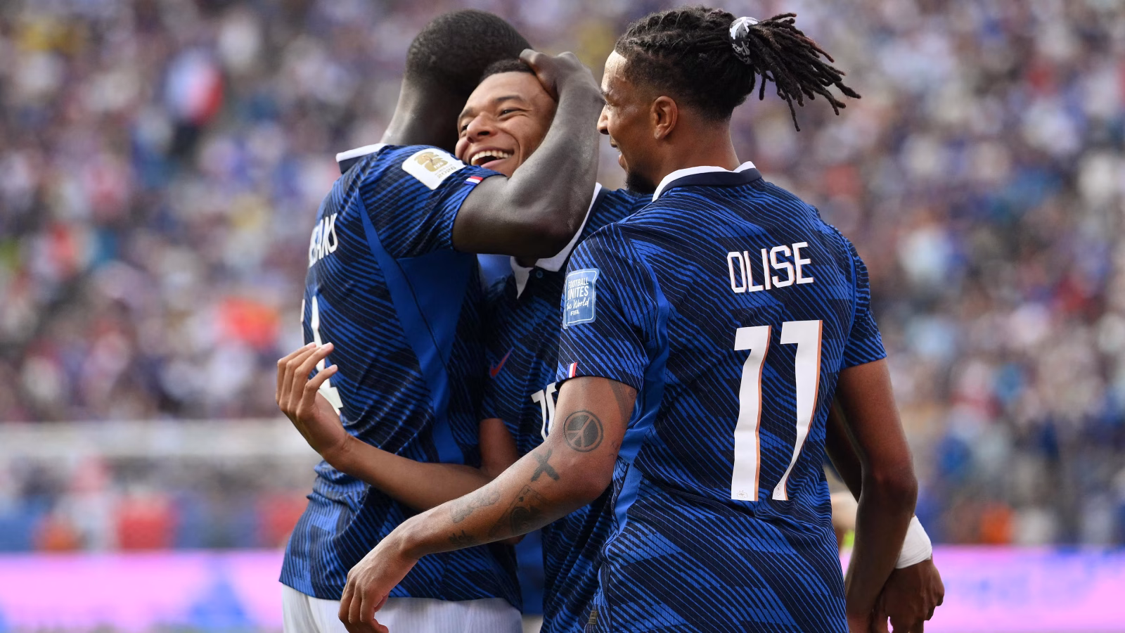Kylian Mbappe celebrating for France during World Cup 2026 as club goal charts highlight Liverpool's Premier League lead